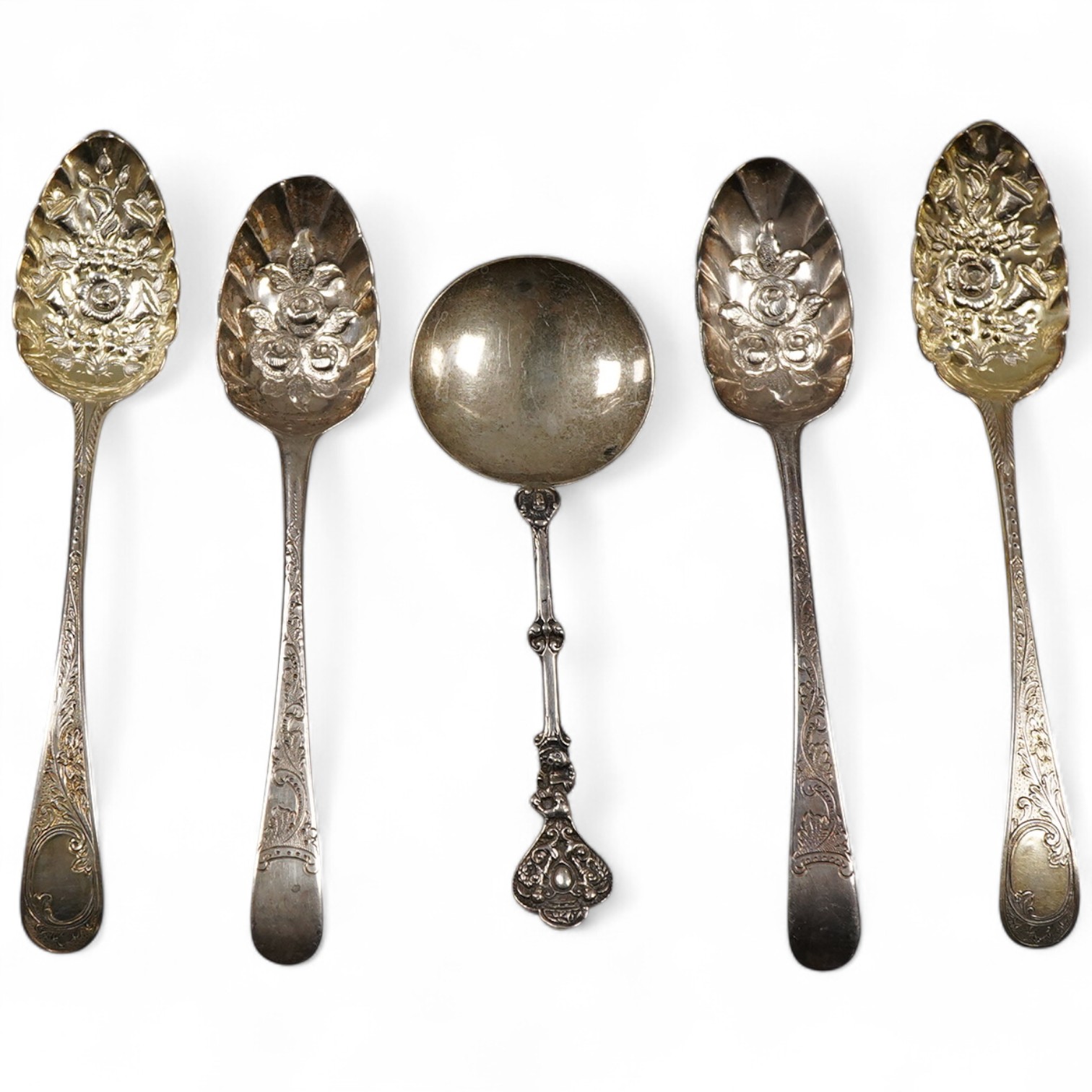 A pair of George III silver gilt Old English pattern berry spoons, London, 1787, 21.8cm, two other earlier silver berry spoons and an Edwardian serving spoon by William Hutton & Sons, London, 1901, 9oz.